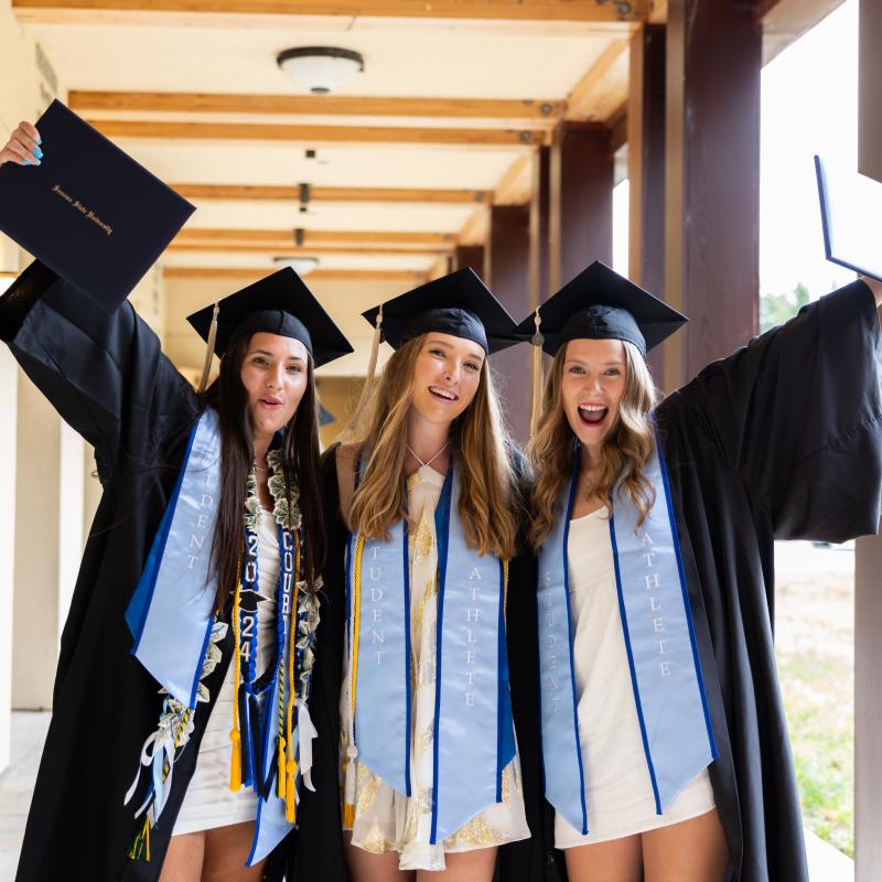 three happy graduates