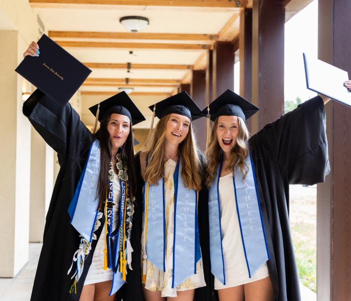 three happy graduates