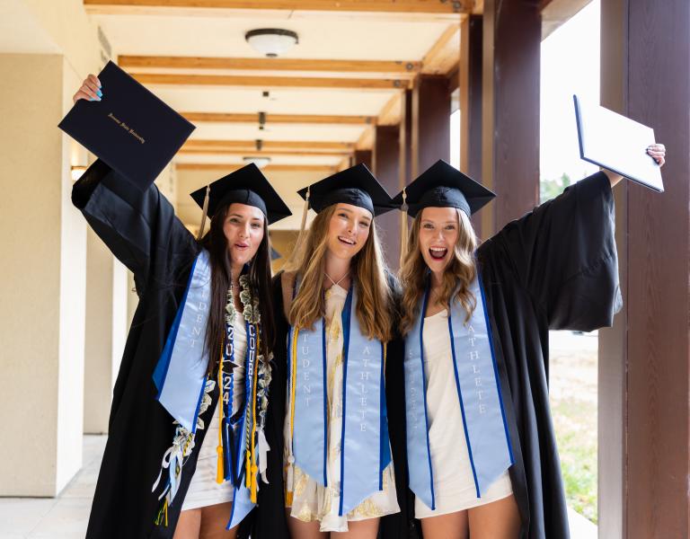 three happy graduates